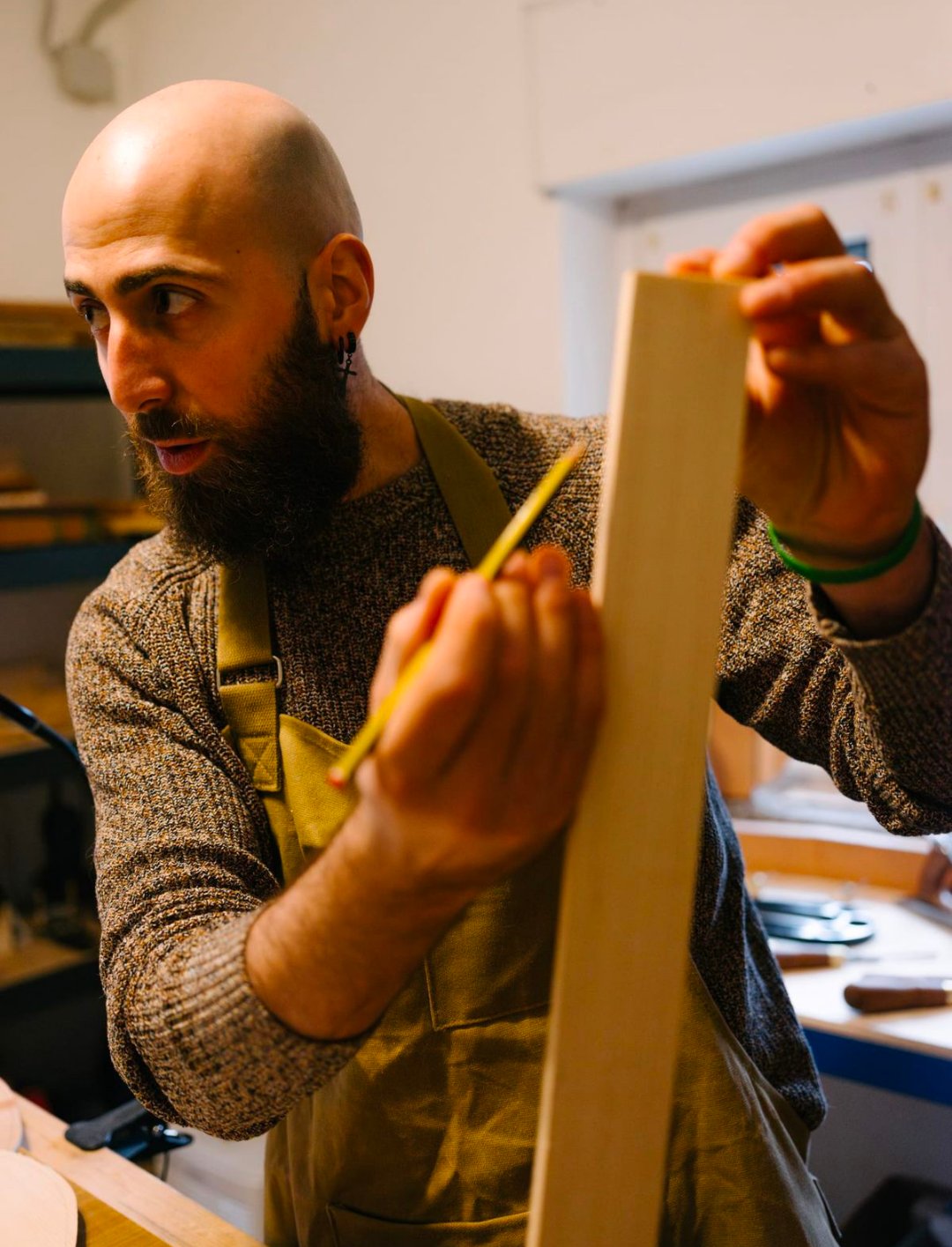 Luca Nunzio Caira inspecting wood in his workshop